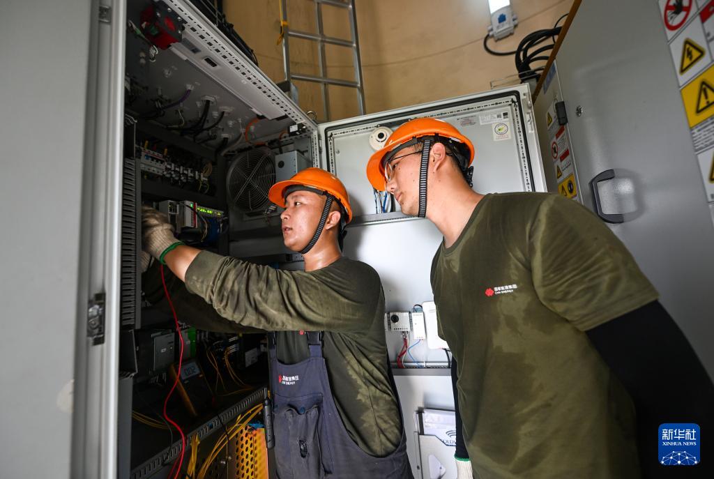 7月10日，在国家能源集团天津龙源新能源有限公司大苏庄风电场，工作人员在风电机组内检查变电设备。新华社记者 赵子硕摄